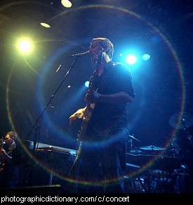 Photo of a man singing at a concert