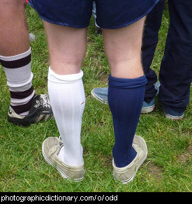 Photo of a man wearing odd socks