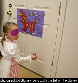 Photo of a child playing pin the tail on the donkey