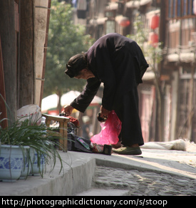 Photo of an old woman stooping