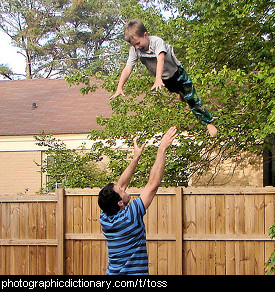 Photo of a man tossing a boy