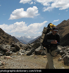 Photo of a man trekking through the mountains