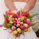 Photo of a woman holding a bouquet of flowers.